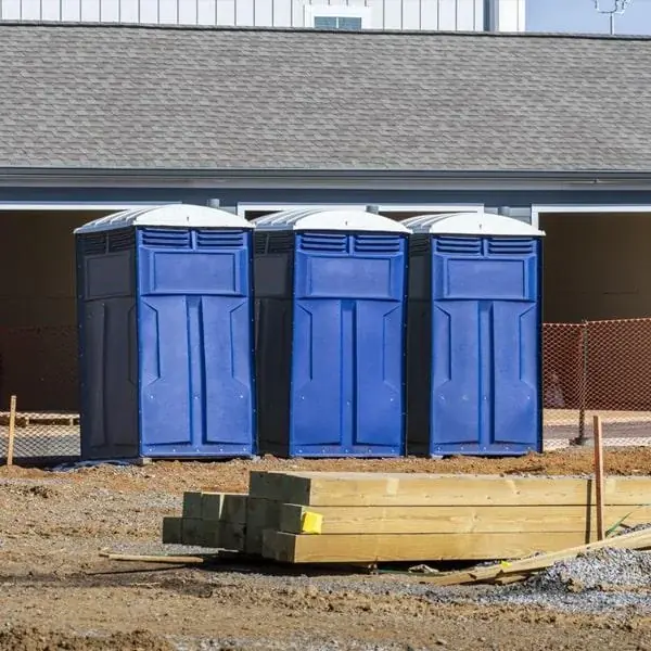 Portable toilets outside a building under construction